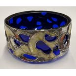 A pierced silver and enamelled salt.