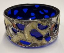 A pierced silver and enamelled salt.