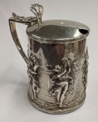 A chased Victorian silver mustard pot.