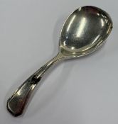 A silver caddy spoon.