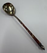 A Russian silver and enamelled spoon.