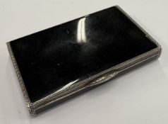 A silver and black enamelled snuff box.