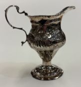 A George III silver cream jug.