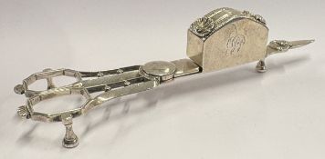 A large and unusual pair of silver candle snuffers.