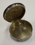 A chased Continental silver pill box.