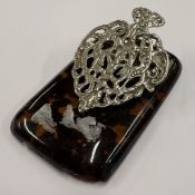 A silver and faux tortoiseshell paper holder.