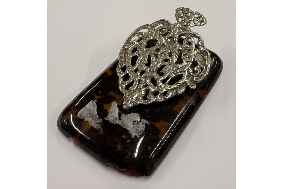 A silver and faux tortoiseshell paper holder. - Image 1 of 2