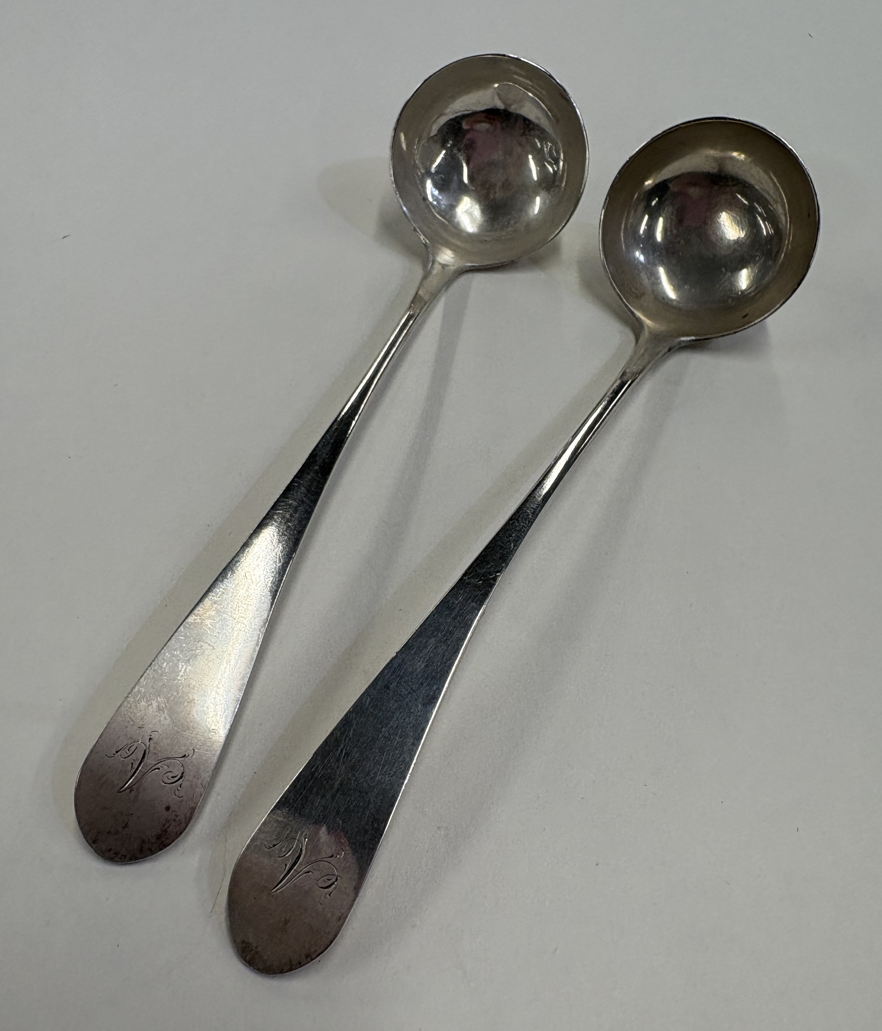 EDINBURGH: A pair of George III Scottish silver toddy ladles.