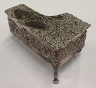 A chased silver model of a piano.