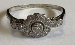 A small diamond daisy-head cluster ring.