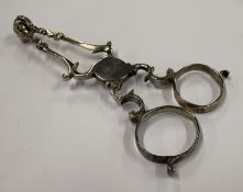 A pair of silver sugar nips.