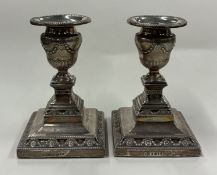 A pair of silver candlesticks.
