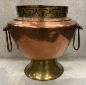 An Antique brass and copper twin-handled jardinière.
