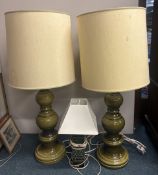 A pair of large green pottery lamps together with