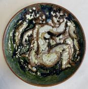 A large terracotta glazed wall charger.