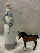 A Lladró figurine depicting a girl with lamb etc.