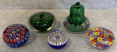 A small collection of glass paperweights.