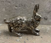 A heavy cast figure of a hare with textured body. Approx. 44 grams. Est. £50 - £80.