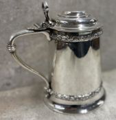 A Victorian silver lidded tankard with chased banded decoration. Birmingham 1865. By F and Co.