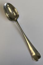 A good quality silver Hanoverian pattern dessert spoon attractively crested to reverse. London 1740.