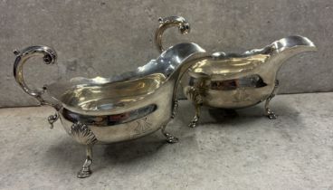 A fine matched pair of 18th Century George III silver sauceboats with matching crested decoration.