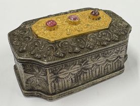 A Continental silver snuff box with gilt and stone decoration to cover. Approx. 90 grams. Est. £