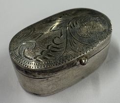An oval engraved silver pill box, bearing English import marks to base. Approx. 4 grams. Est. £