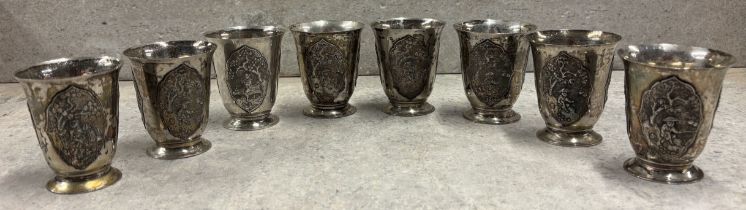 A set of eight Continental silver beakers with embossed decoration. Approx. 480 grams. Est. £