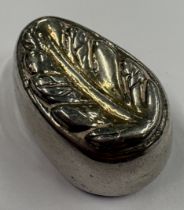 A silver paperweight in the form of a leaf. Approx. 14 grams. Est. £30 - £40.