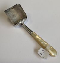 A William IV silver and MOP caddy scoop with bright-cut decoration to bowl. Birmingham 1833. By