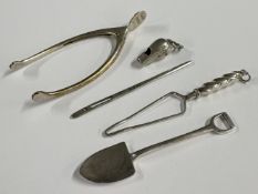 An attractive pair of silver wishbone tongs together with a whistle etc. Approx. 25 grams of gross
