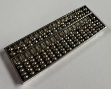 A small Chinese silver model of an abacus. Approx. 20 grams. Est. £20 - £30.