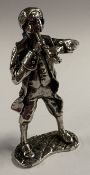 A heavy cast silver figure of a musician. Approx. 32 grams. Est. £30 - £50.