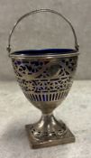 An 18th Century George III silver swing-handled basket with pierced decoration and removable BGL.