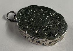 An attractive engraved silver vinaigrette of oval form with loop top. Birmingham. By FM. Approx.