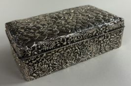 A Japanese silver cigar box with floral decoration, bearing Pure Silver character marks to base.