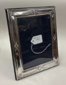 A silver-mounted picture frame. Sheffield. Est. £30 - £40.