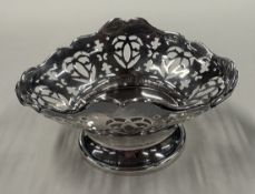 A pierced silver bonbon dish on pedestal base. Birmingham 1911. By Deakin & Francis. Approx. 55