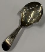 An 18th Century silver caddy spoon with pierced star decoration. Birmingham 1799. By John Taylor.