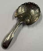 A George III silver caddy spoon with bright-cut decoration. Birmingham 1823. Approx. 5 grams.