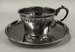 BOULENGER: An attractive French silver teacup and saucer with chased decoration. Approx. 127