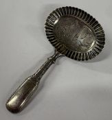 A George III silver caddy spoon with bright-cut decoration to bowl. Birmingham 1819. By John Taylor.