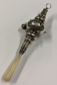 A child's large and heavy silver rattle with MOP handle. Birmingham 1922. Approx. 77 grams. Est. £