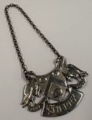 A silver wine label for 'Sherry' cast with swans and coat of arms to centre contained within