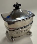 A silver tea caddy with hinged cover. London 1909.