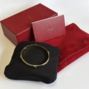 CARTIER: A good 18 carat gold bracelet with concealed clasp, box and paperwork.