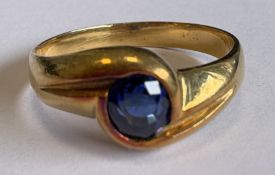 An 18 carat French gold ring with large oval sapphire.