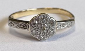 A small diamond cluster ring in 18 carat gold setting.