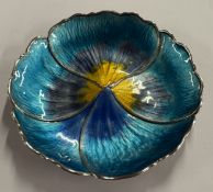 A silver and enamelled dish in the form of a flowe