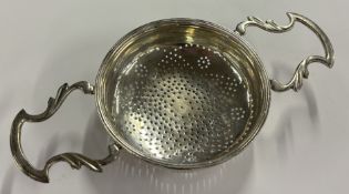 An 18th Century silver lemon strainer in the Georg